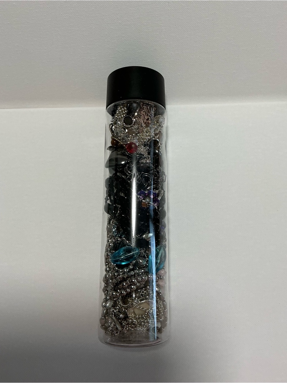 Clear Jewelry Tube Filled with 25 Mixed Costume Jewelry Multicolor Items.